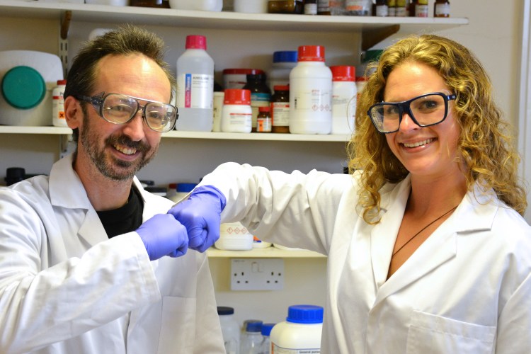 Prifysgol Aberystwyth University researchers David Whitworth and Sara Mela strike a pose in the lab. The Associated Press