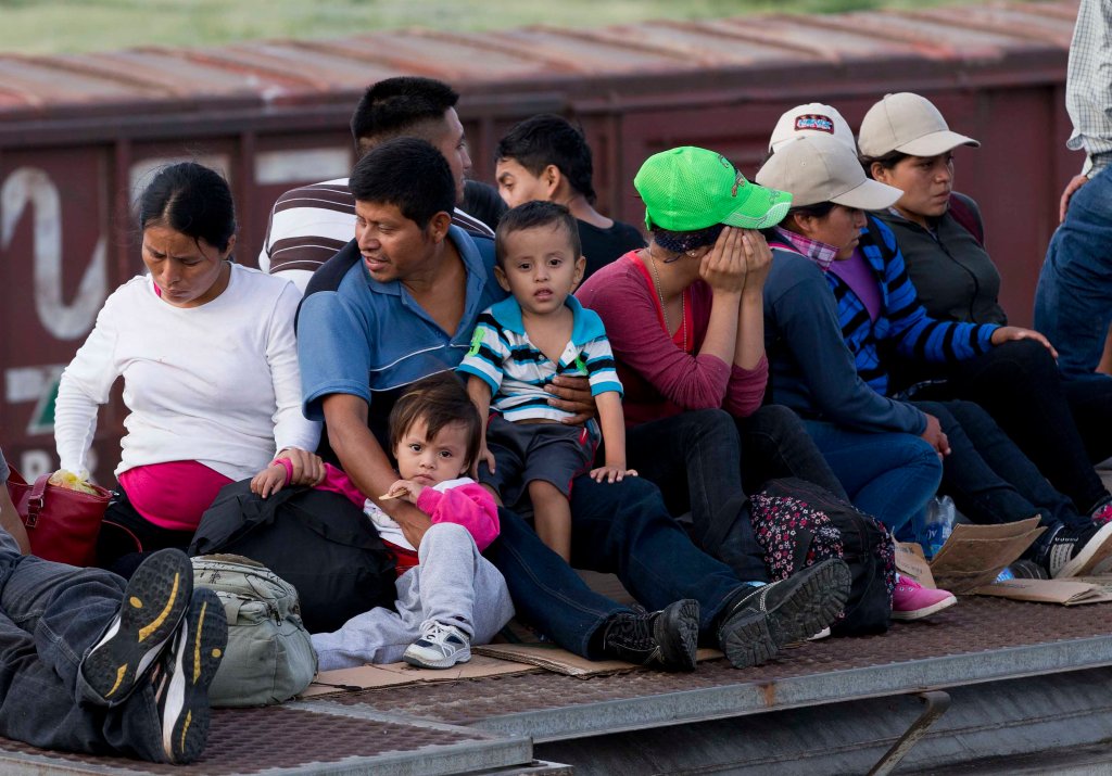 Central American migrants ride a freight train during their journey toward the U.S.-Mexico border in Ixtepec, Mexico, this month. Maine Gov. Paul LePage says he has learned that eight cross-border children have been placed in Maine.