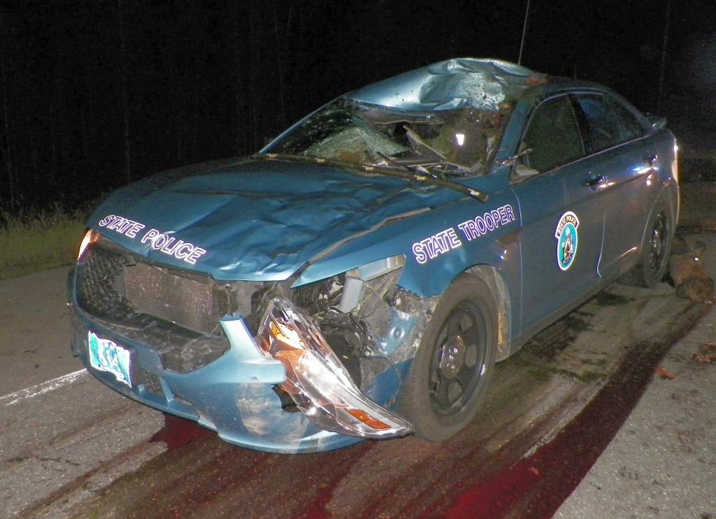 Trooper Dennis Quint's 2013 Ford Interceptor was demolished when it collided with a moose. northern Aroostook County. Quint was transported to a  hospital with cuts to his head and hand. He was treated and released. 

Maine Department of Public Safety photo
 