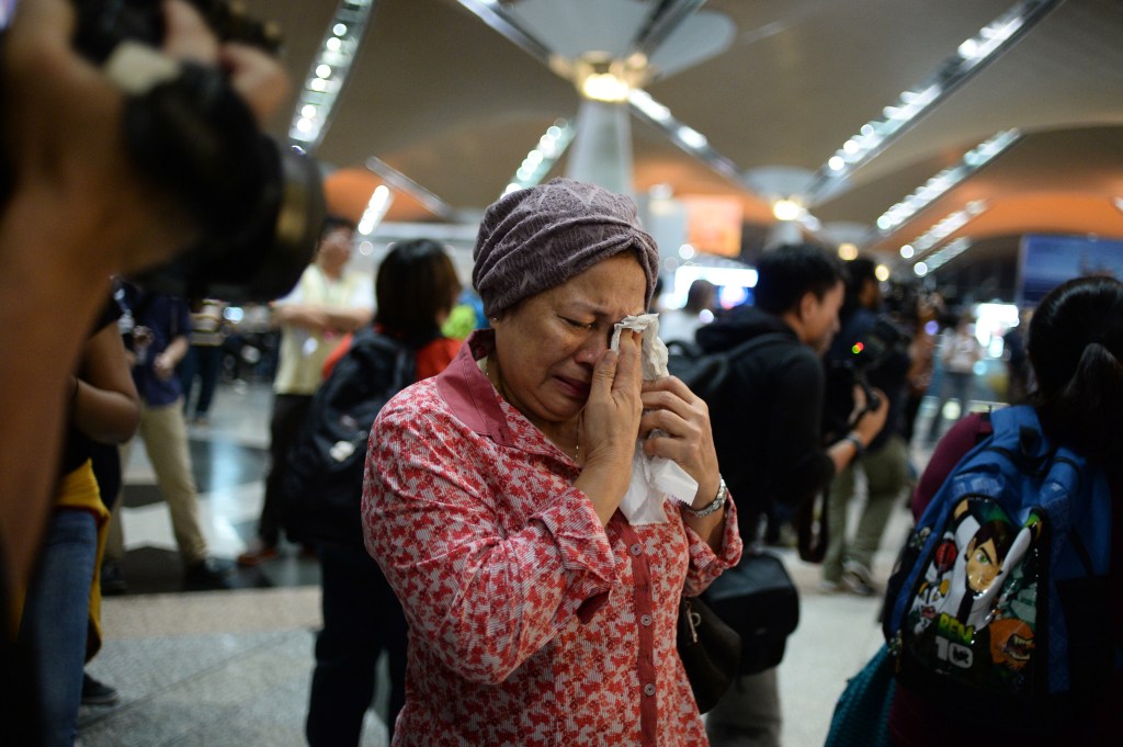 A woman reacts to news regarding a Malaysia Airlines plane that crashed in eastern Ukraine at Kuala Lumpur International Airport in Sepang, Malaysia, on Friday.