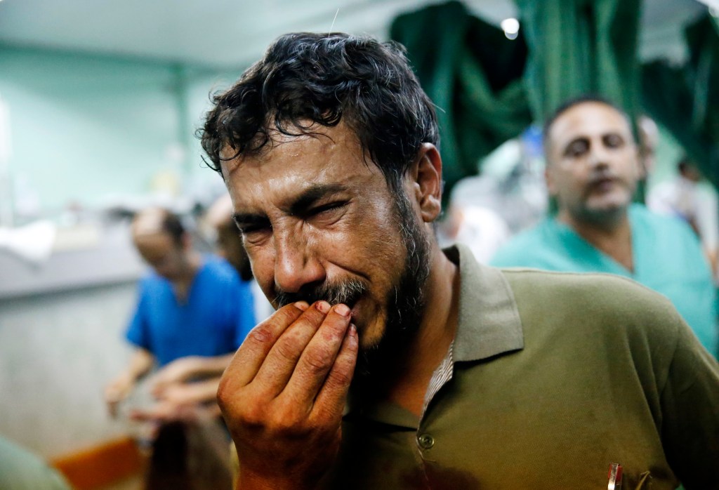 A Palestinian man cries after bringing a child who was wounded in an Israeli strike on a compound housing a U.N. school in Beit Hanoun to the emergency room of the Kamal Adwan hospital in Beit Lahiya on Thursday.

The Associated Press