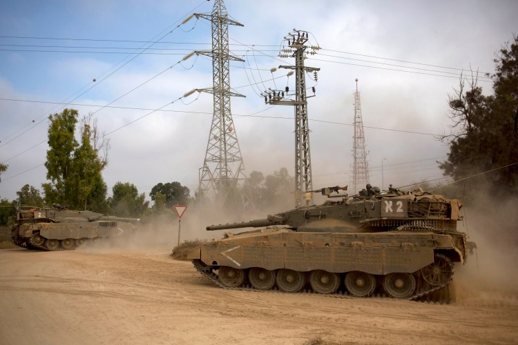 Israeli tanks move near the Israel and Gaza border in July 2014. The Associated Press