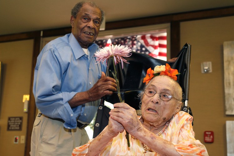 Gertrude Weaver, right, talks with her son Joe Weaver, Thursday, July 3, 2014 at Silver Oaks Health and Rehabilitation Center in Camden, Ark., a day before her 116th birthday. The Gerontology Research Group says Weaver is the oldest person in the United States and second-oldest person in the world.