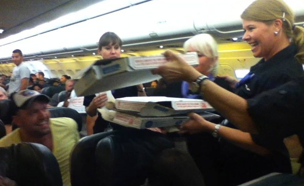 In this photo by a passenger and sent to KUSA-TV, a Frontier Airlines flight attendant passes out pizza to passengers aboard a Denver-bound flight diverted to Cheyenne, Wyo., Monday.

The Associated Press