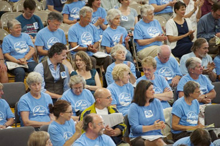Citizens in favor of the ban to keep tar sand oil from entering the harbor in South Portland wear blue shirts  during the South Portland City Council meeting Monday. 
Logan Werlinger/Staff Photographer