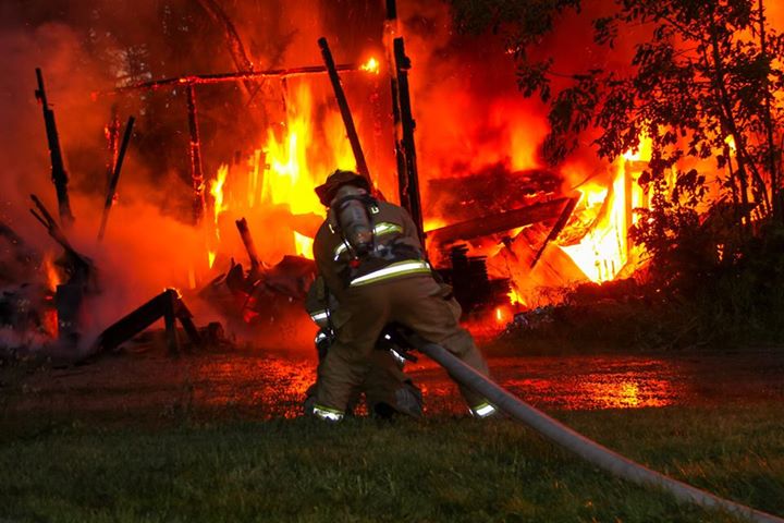 Firefighters in South Berwick battle a fire at a barn on York Woods Road that was hit by lightning Wednesday. Firefighters say lightning also caused a fire in a garage attached to a home on Emery’s Bridge Road.