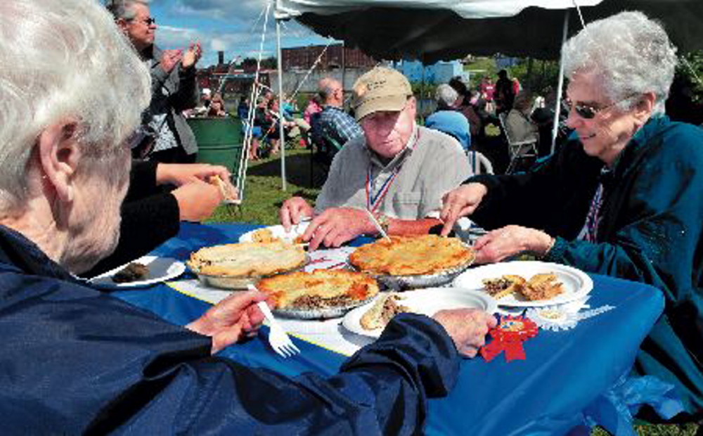 Judges sample tourtiere during a competition at the 2013 Franco-American Festival in Waterville. 