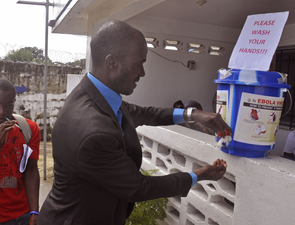 A man washes his hands before entering a public building as part of a drive to prevent the spread of the Ebola virus in the city of Monrovia, Liberia, on Thursday.