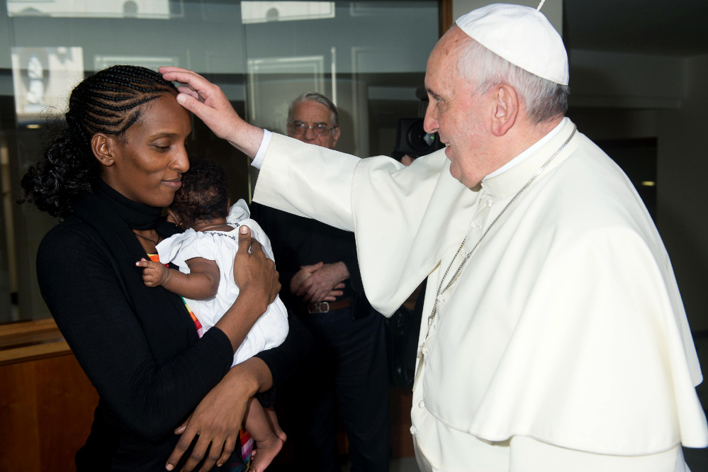 Meriam Ibrahim, originally from the Sudan, meets with Pope Francis on July 24 at the Vatican. Ibrahim, seen holding her daughter, had faced a death sentence, later overturned, for apostasy because she married a non-Muslim man.