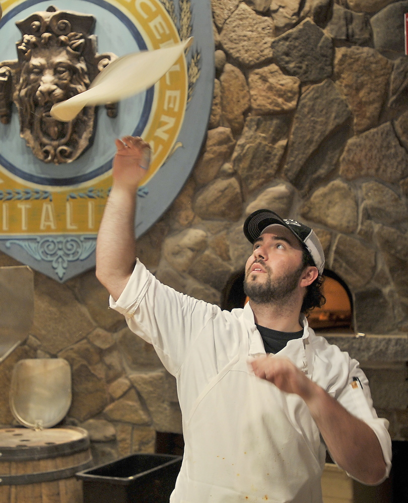 Noah DiLeo spins a pizza crust at Tuscan Bistro.