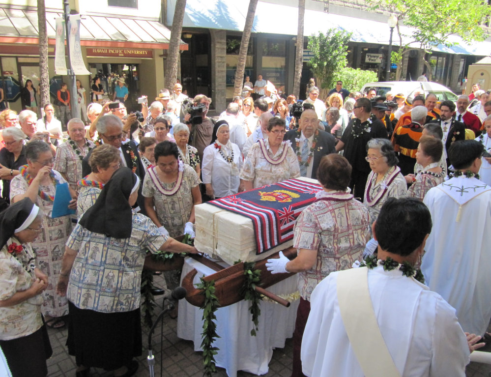 A casket containing the remains of St. Marianne Cope arrives at the Cathedral of Our Lady of Peace in downtown Honolulu for a ceremony and Mass on Thursday. A sealed zinc-coated metal box containing the bones will be placed upright in a koa wood and glass cabinet in the cathedral. The Associated Press