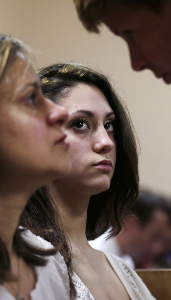 Abigail Hernandez, center, listens to her mother, Zenya Hernandez, left, talk with New Hampshire Senior Assistant Attorney General Jane Young on Tuesday.