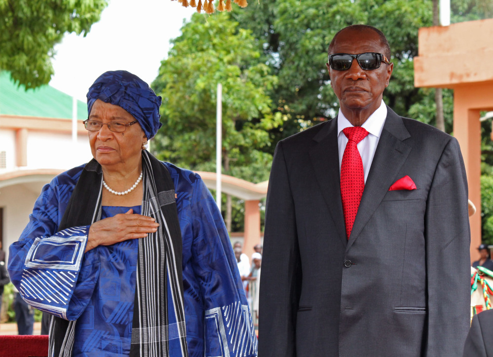 Liberia President Ellen Johnson Sirleaf, left, and Guinea President Alpha Conde, right, pose after meetings about the Ebola virus in Conakry, Guinea, on Friday. An Ebola outbreak has killed more than 700 people in West Africa and sickened more.