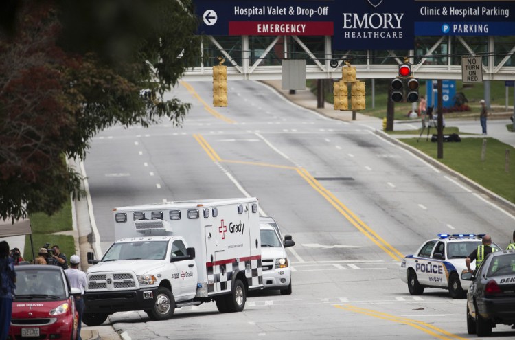 An ambulance carrying Dr. Kent Brantly arrives at Emory University Hospital in Atlanta on Saturday afternoon. Another American with Ebola is expected to join him at the hospital in a few days.