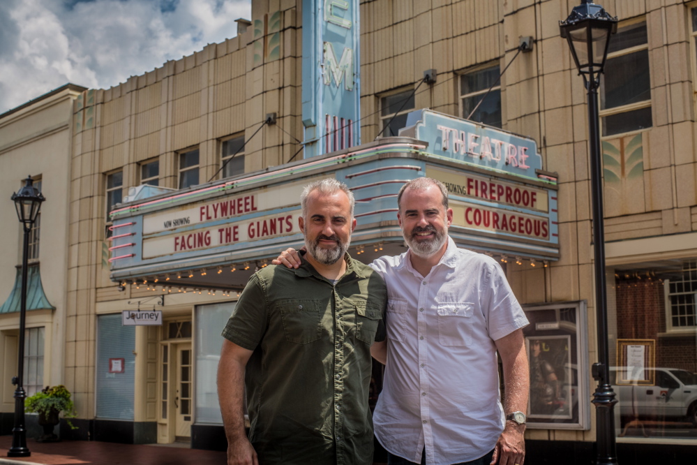 Stephen, left, and Alex Kendrick, pose outside The Gem Theater after shooting several car scenes along the main drag in downtown Kannapolis, N.C., for their fifth movie. The Kendrick brothers, who just wrapped up filming their fifth project, are making movies that could see wider release as distributors pay attention to the box office trends in the traditional Bible Belt and beyond.