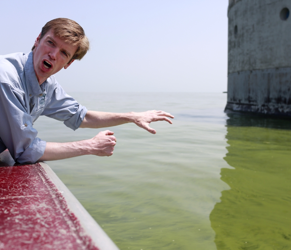 Collin O’Mara, president and CEO of the National Wildlife Federation, explains Sunday about the algae buildup in Lake Erie that has created toxins and a greenish coloration near Toledo’s water intake facility.