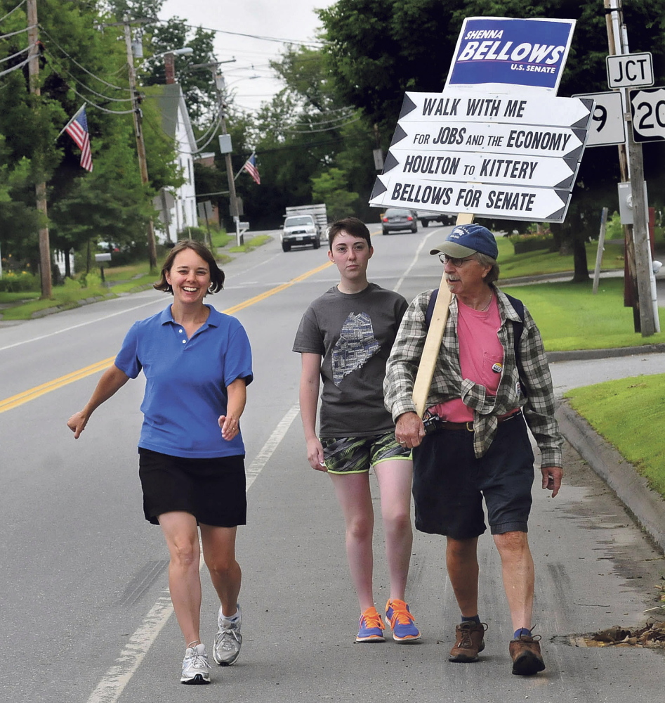 U.S. Senate candidate Shenna Bellows, left, walks along School Street in Unity last week as part of a 350-mile trip that should reach Kittery by Aug. 12. David Leaming/Morning Sentinel