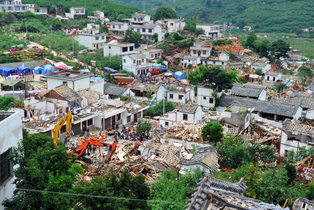 Collapsed houses are seen in Ludian County of Zhaotong City in southwest China’s Yunnan Province, Monday, Aug. 4, 2014, following Sunday’s strong earthquake.  Rescuers dug through shattered homes Monday looking for survivors of the strong earthquake in southern China’s Yunnan province that killed hundreds and injured more than a thousand people.
