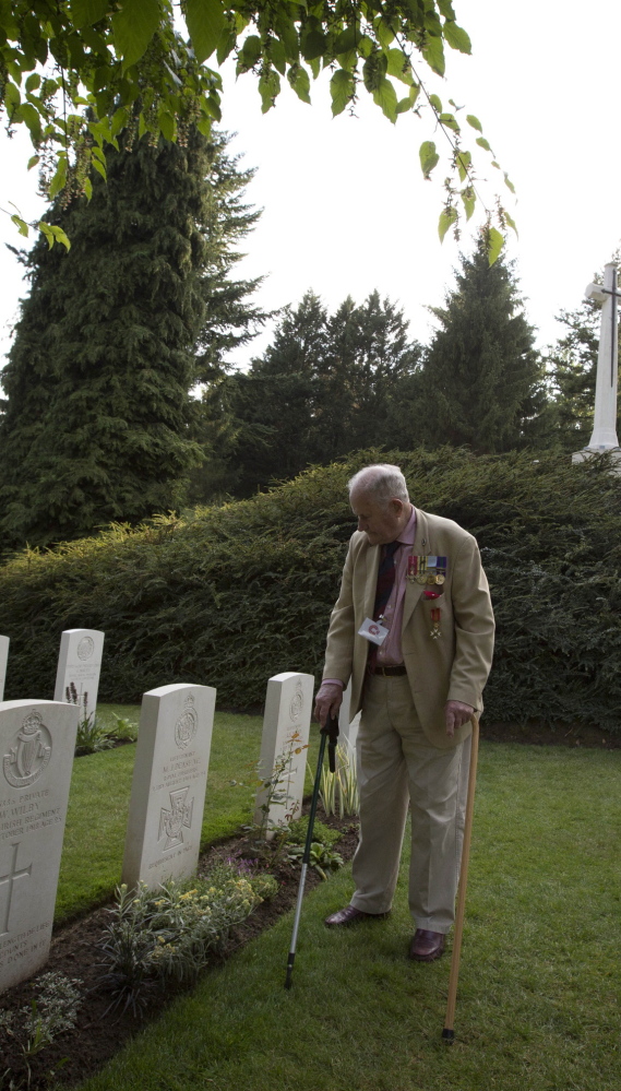 Former British Maj. Maurice French, 84, stands in front of the grave of his uncle, World War I Victoria Cross recipient Maurice Dease, during the ceremony Monday in Saint-Symphorien, Belgium.