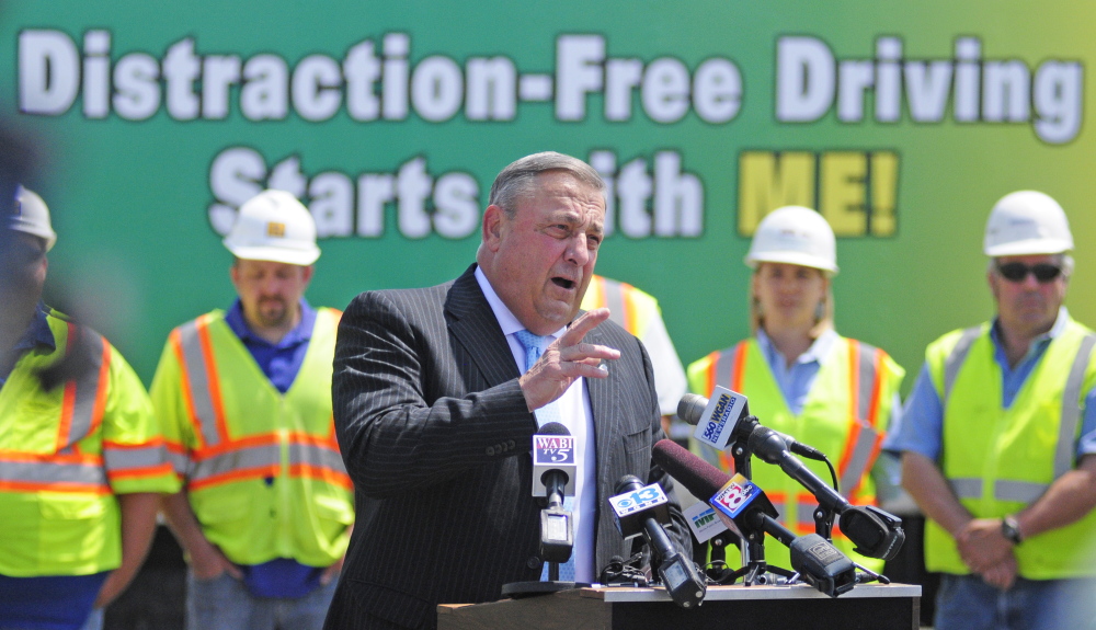 Gov. Paul LePage talks about distracted driving on Tuesday during a news conference in the parking lot outside State Police headquarters in Augusta.