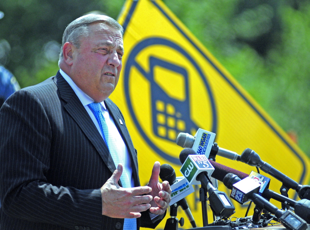 Gov. Paul LePage addresses distracted driving on Tuesday during a news conference in the parking lot outside State Police headquarters in Augusta.