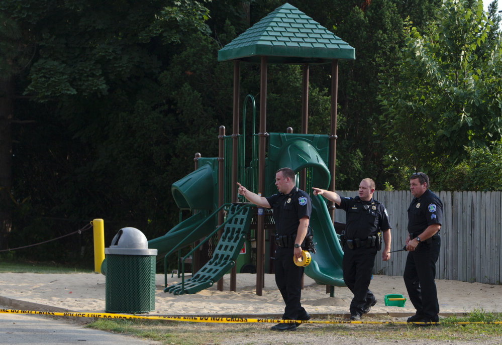 Kentwood police investigate a stabbing that occurred at a playground in Pinebrook Village mobile home park in Kentwood, Mich., on Monday.