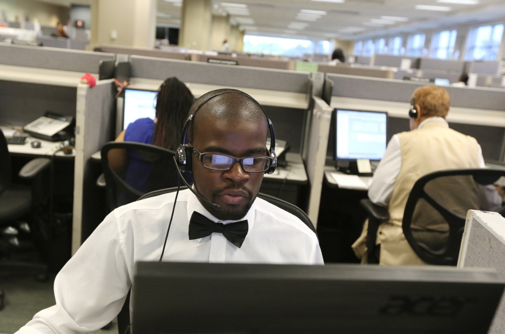 Detroit resident Keontay Kelley, 26, works as a customer service representative at Dialog Direct call center in Highland Park, Mich., on Wednesday, July 30, 2014. Kelley says he enjoys his job because he likes helping people. (Jessica J. Trevino/Detroit Free Press/MCT)