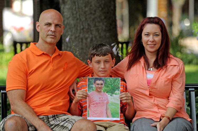 Ray, Nason and Amy Berthelette of Pittsfield with a picture of Nolan, 14, who died July 19.