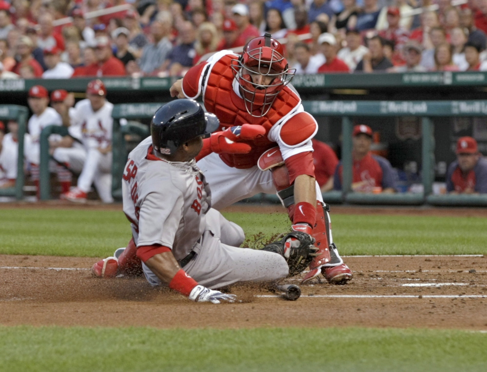Catcher A.J. Pierzynski, remember him, tags out Boston’s Yoenis Cespedes, who tried to score from third on a grounder in the second inning Tuesday. The Cardinals beat the Red Sox 3-2 by scoring a run in the bottom of the eighth in a rematch of last year’s World Series.