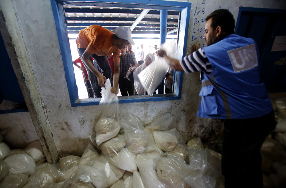 Palestinians crowd a window for food aid at a United Nations distribution center in the Shati refugee camp in Gaza City on Wednesday.