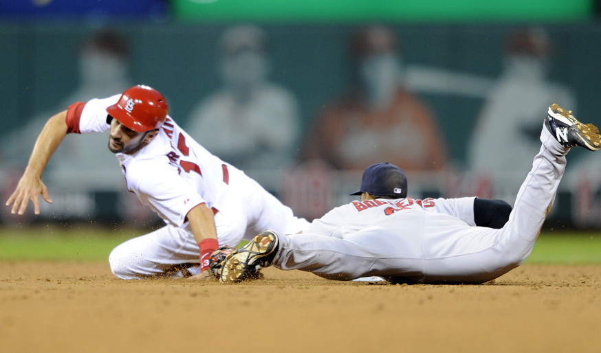 Matt Carpenter, left, of St. Louis is tagged out stealing by Boston’s Xander Bogaerts on Thursday night.