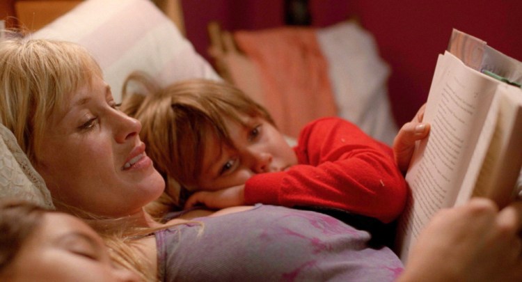 Patricia Arquette, as Mom, reads to her children, played by Ellar Coltrane and Lorelei Linklater, in “Boyhood.” “I always knew I was working on something beautiful” she says about working on the film over the course of 12 years.