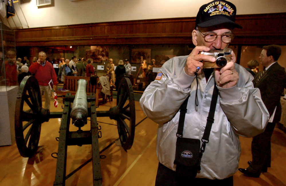 World War II veteran Richard Marowitz takes a picture of an exhibit on opening day in 2002 of the New York State Military Museum and Veterans Research Center in Saratoga Springs, N.Y. Marowitz, who found Adolf Hitler’s top hat, died Wednesday. He was 88.