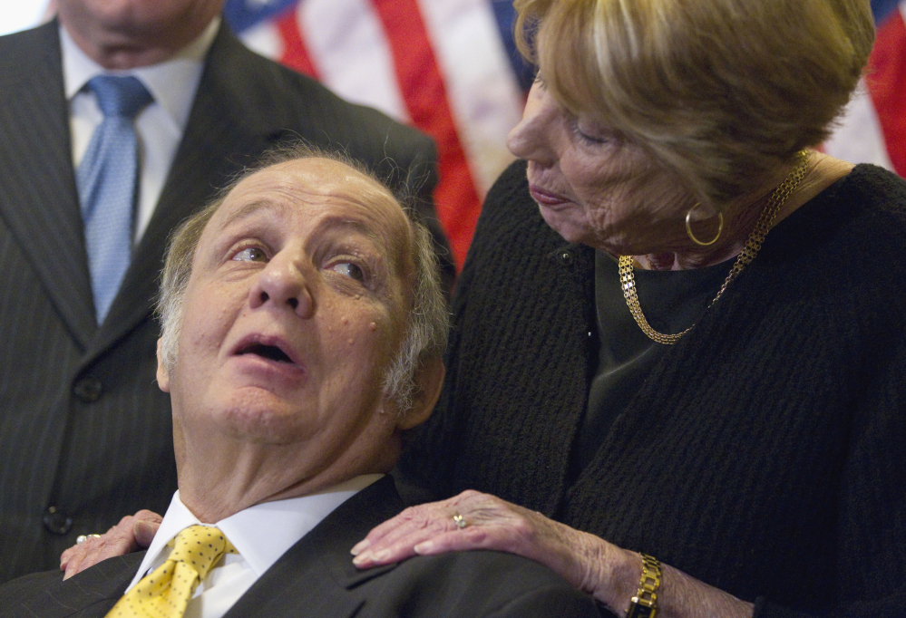 Former White House press secretary James Brady, left, who was left paralyzed in the Reagan assassination attempt, looks at his wife Sarah Brady during a 2011 news conference on Capitol Hill in Washington marking the 30th anniversary of the shooting.