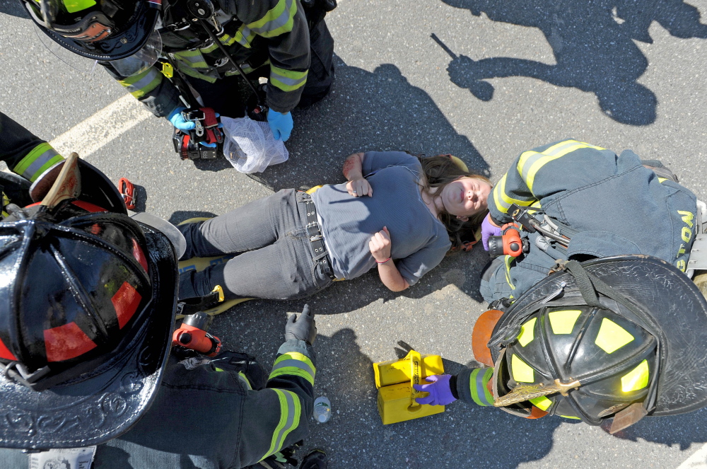 Farmington firefighters treat a person portraying a victim injured by a car bomb during a Homeland Security training exercise on Friday.