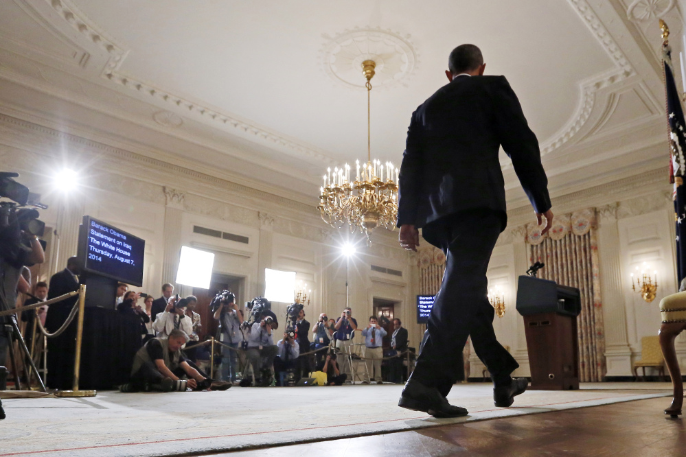 President Barack Obama approaches the podium to speak about the situation in Iraq in the State Dining Room at the White House in Washington.