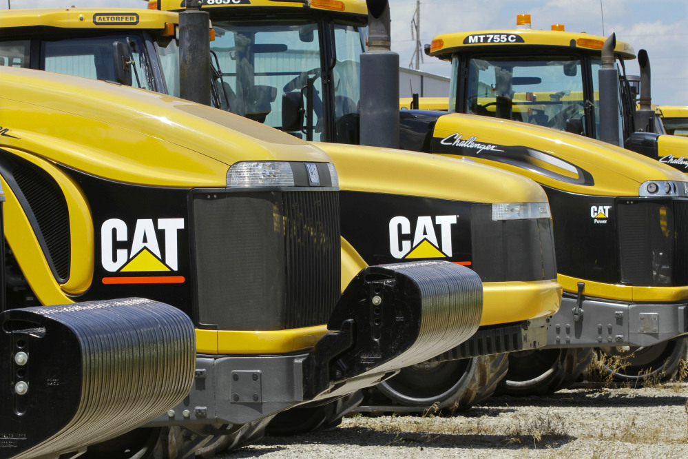  In this June 20, 2012 file photo, earth-moving tractors and equipment made by Peoria, Ill.-based Caterpillar Inc. are seen in Clinton, Ill. The Associated Press