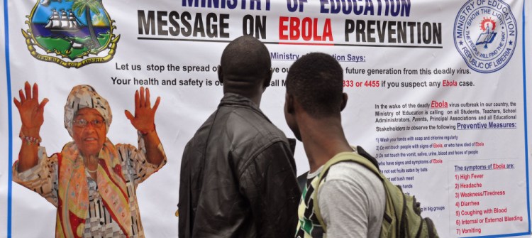 The image of Liberia President Ellen Johnson Sirleaf, left, appears on a public information banner warning people about the Ebola virus in the city of Monrovia, Liberia.