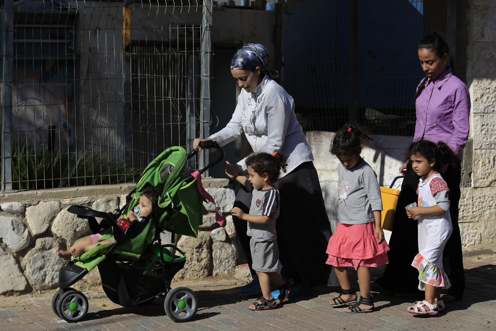 Israelis flee after a rocket fired from Gaza hit in a residential neighborhood of the southern city of Sderot on Friday.