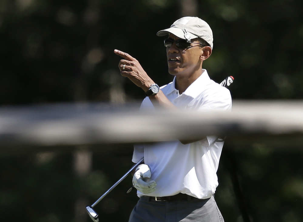 Happy to shed his suit,  President Obama is all smiles at Farm Neck Golf Club.