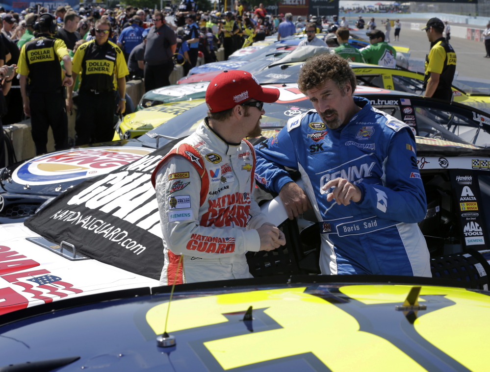 Dale Earnhardt Jr., left, and Boris Said talk on pit row Saturday before a qualifying session for Sunday’s NASCAR Sprint Cup Series race at Watkins Glen International in Watkins Glen, N.Y. Earnhardt finished seventh in qualifying.