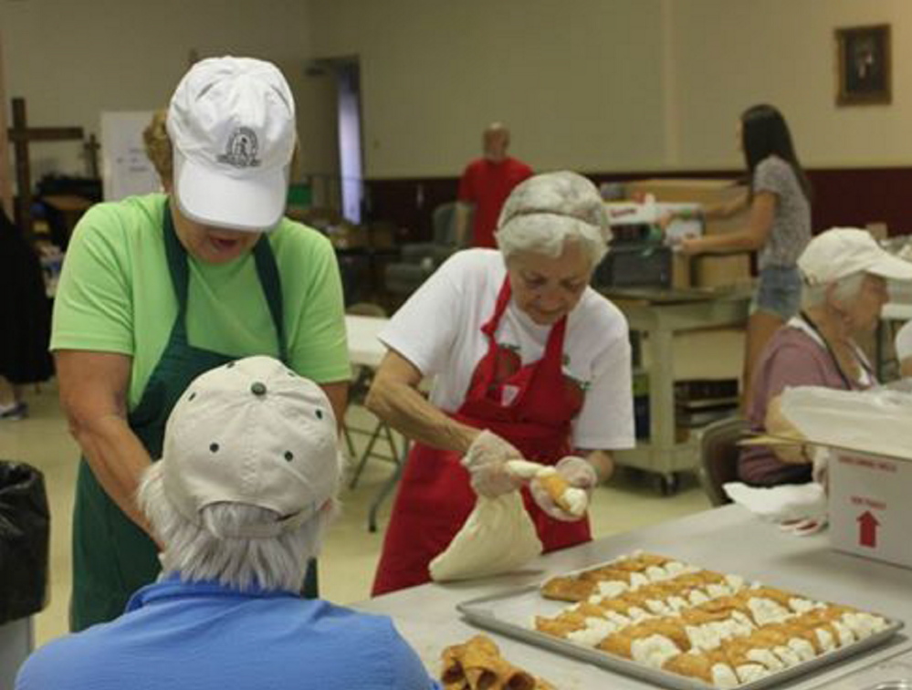 Members of the St. Peter’s Italian Bazaar baking crew fill cannoli shells in advance of the 2013 festival. This year’s event will be held Saturday and Sunday, featuring live music, family games and a wide array of treats.
