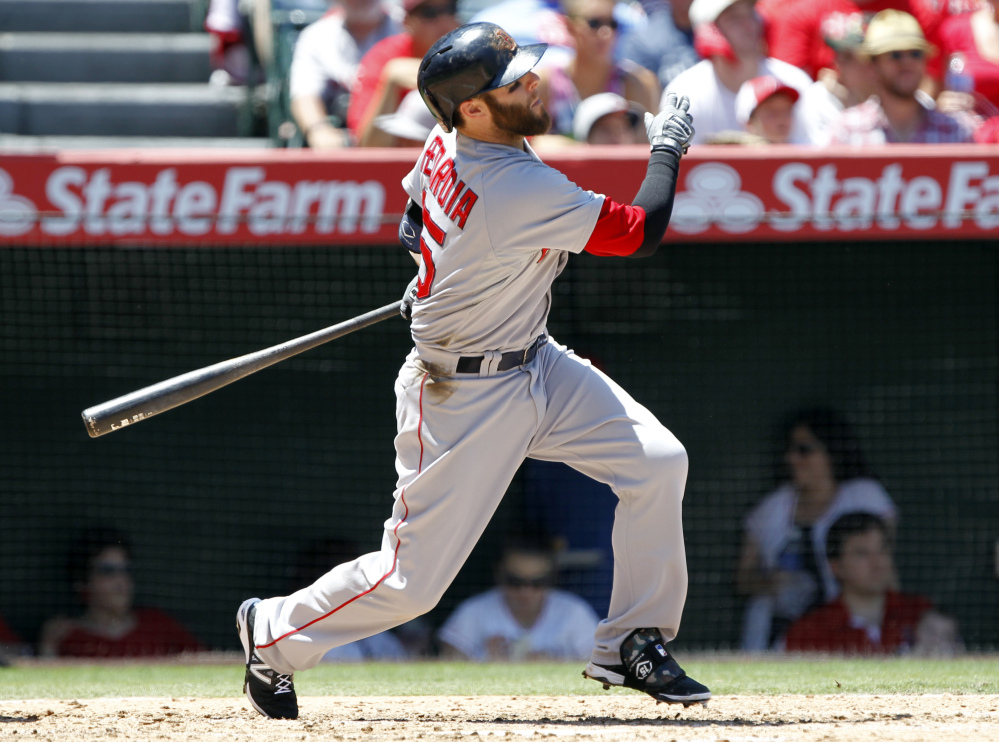 Red Sox second baseman Dustin Pedroia hits a double in the fourth inning against the Los Angeles Angels on Sunday in Anaheim, Calif.