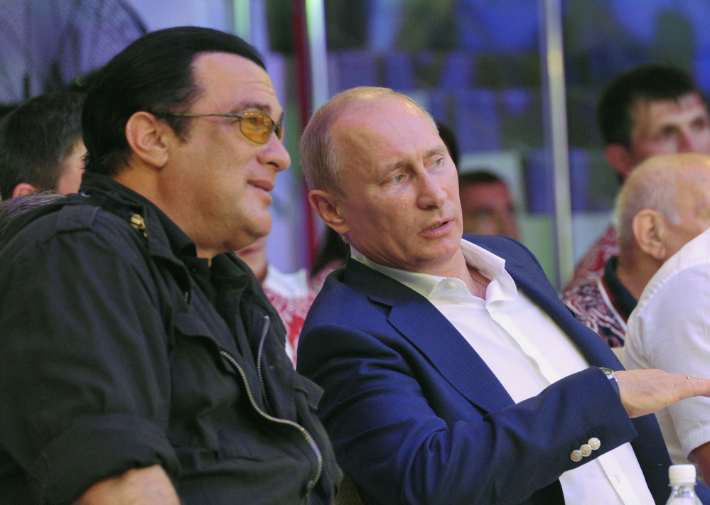 Actor Steven Seagal, left, and Russian President Vladimir Putin watch a mixed martial arts championship in the Black Sea resort of Sochi, Russia, in August 2012. Seagal reportedly performed Saturday at a concert in the breakaway region of Crimea on a stage decorated with the flag of pro-Russian separatists fighting in eastern Ukraine.