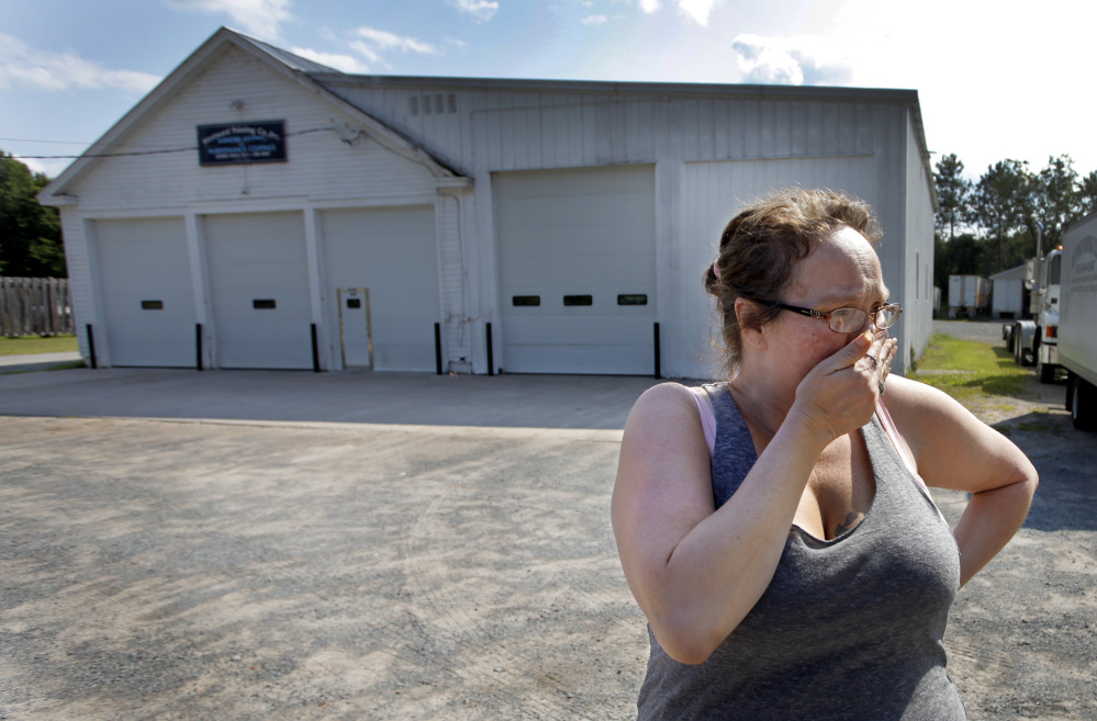 Lynn Hardy cries Sunday Aug. 10, 2014, in front of the Westward Painting Co. Inc in Lyons Falls, N.Y., where race car driver Kevin Ward Jr. kept and worked on his car and worked with his father Kevin Sr. in the painting business.