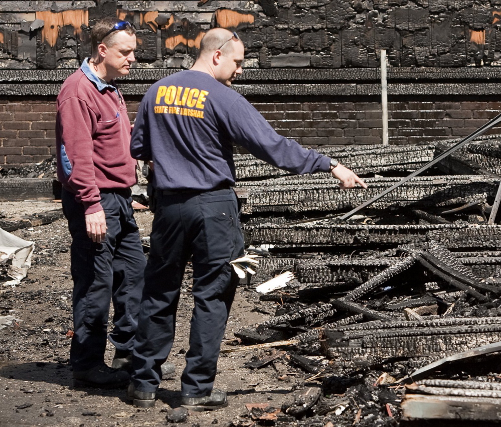 Investigators comb through the rubble of a Lewiston fire that started May 3, 2013. The fire destroyed four apartment buildings on Bartlett and Pierce streets.
