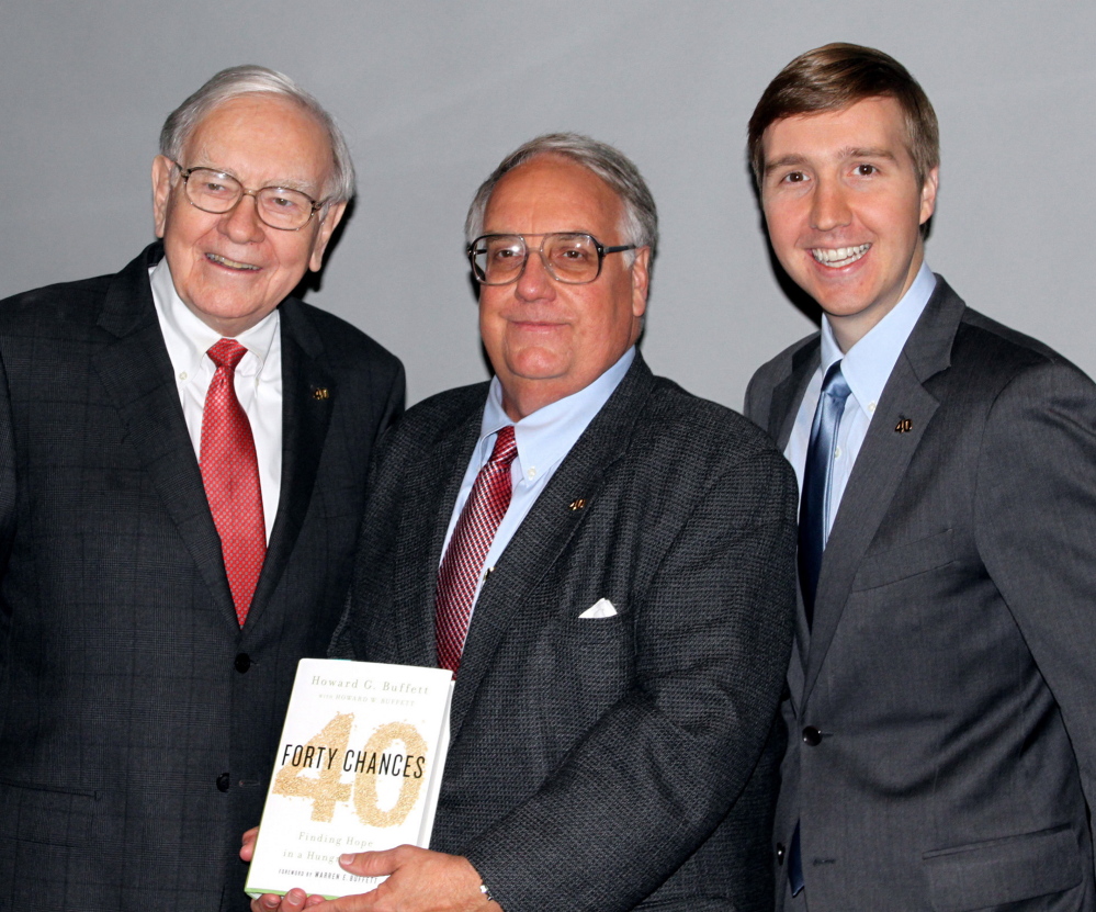 Warren Buffett, left, is giving most of his billions to charity rather than his son Howard G. Buffett, center, standing with his son Howard W. Buffett.