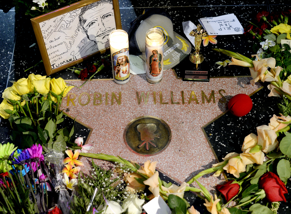 Flowers are placed in memory of actor/comedian Robin Williams on his Walk of Fame star in the Hollywood district of Los Angeles, Monday.