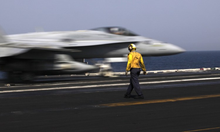 A U.S. F/A-18 fighter jet takes off for Iraq from the flight deck of the aircraft carrier USS George H.W. Bush on Monday. U.S. military officials say American aircraft struck and destroyed several vehicles Sunday that were part of an Islamic State group convoy moving to attack Kurdish forces defending the northeastern Iraqi city of Irbil.