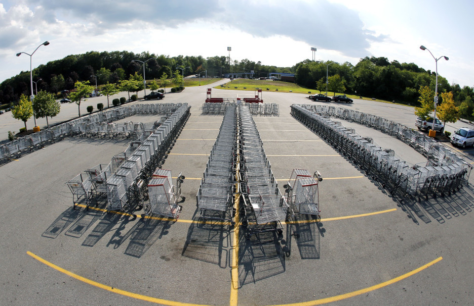 Shopping carts are arranged to form the letters “ATD” in the parking lot of a Market Basket Supermarket in North Andover, Mass., on Aug. 11 in support of former CEO Arthur T. Demoulas.